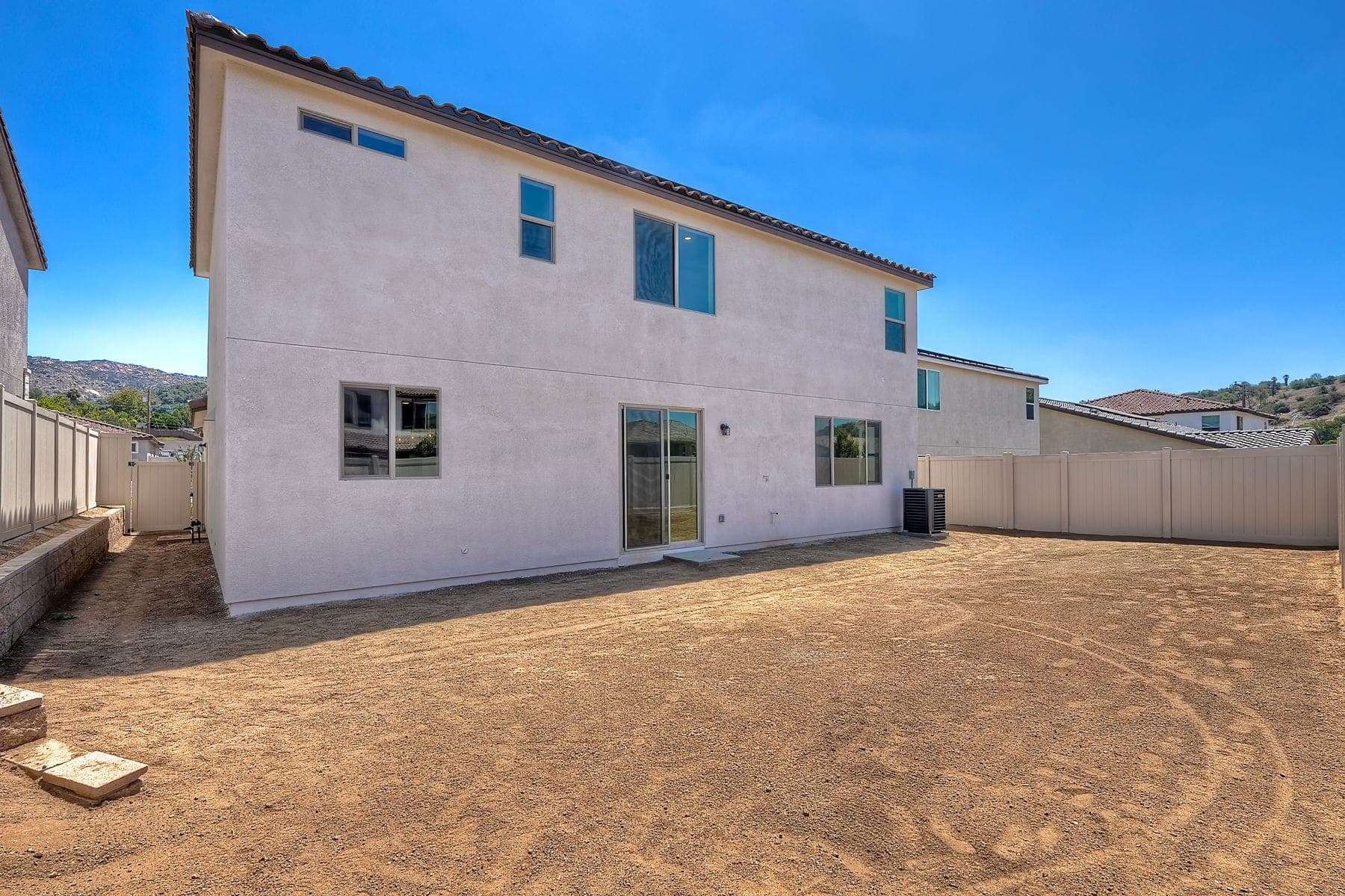 Escondido backyard — dirt lot versus lush green lawn